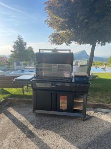 a grill sitting on the ground next to a park at Il Sentiero dei Goti San Marino e Montefeltro in Monte Grimano Terme
