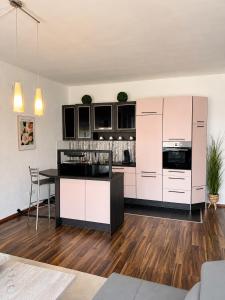 an open kitchen with white cabinets and a table at City Loft Traum Quartier Apartments in Siegen +11 photos