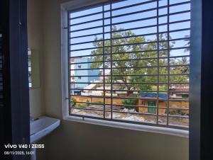 a bathroom with a window with a view of a train at SRIPADAVALLABHANIVAS2 pithapuram in Pithāpuram +18 photos