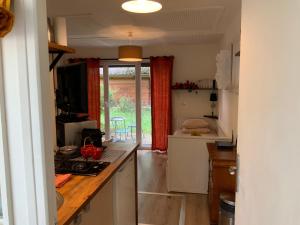a kitchen with a counter top and a kitchen with a window at Studio Tennis Riviere in Annecy
