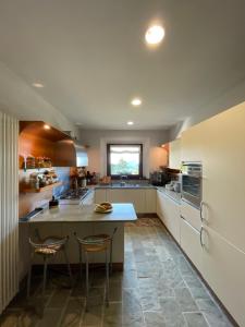 a kitchen with a counter and two chairs in it at Il Sentiero dei Goti San Marino e Montefeltro in Monte Grimano Terme