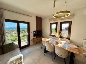 a dining room with a table and chairs and a couch at Pelion PNOES Luxury Seaview Villa with priv Garden in Káto Lekhónia