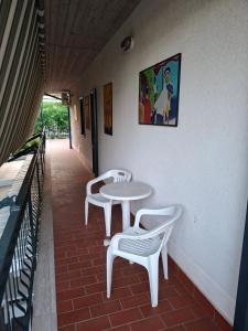 two white tables and chairs on a patio at Blue Coast Sicily in Fondachello