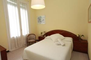 a bedroom with a bed with a bow on it at Pension La Calma in Barcelona