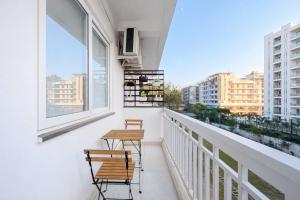 a balcony with two chairs and two windows at Live Free Hostel Dehradun in Dehradun