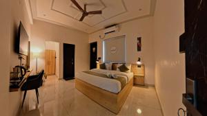 a bedroom with a bed with a ceiling fan at Live Free Hostel Dehradun in Dehradun