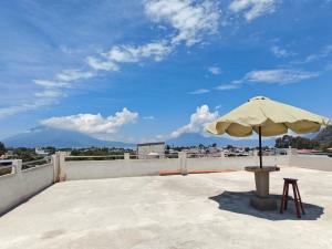 a umbrella sitting on top of a roof at Casa Hormiga in Panajachel