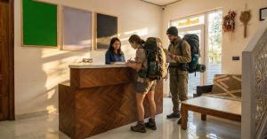 a group of people standing at a counter at Live Free Hostel Dehradun in Dehradun