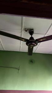 a ceiling fan is hanging from a ceiling at Best White House Hotel in Umunede