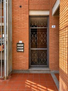 a door on a brick building with a red brick at Civico 3 - Alloggio Turistico in Fiano Romano