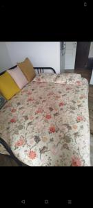 a bed with a flowered blanket on top of it at Casa Domingos Cales De Mallorca in Calas de Mallorca
