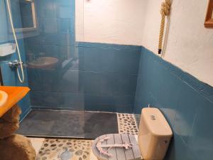 a blue tiled bathroom with a toilet and a sink at Casita Sofia in Caleta de Sebo +8 photos