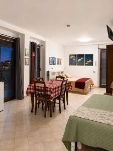 a living room with a table and chairs and a bed at Civico 3 - Alloggio Turistico in Fiano Romano