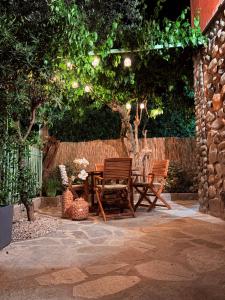 a patio with a table and chairs under a tree at Crueza de ma in Bonassola