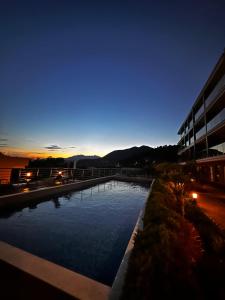 a swimming pool in front of a building at night at Serenity De Lluxe in Kavač +1 photo