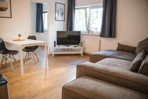 a living room with a couch and a table at Wilten 1 in Innsbruck