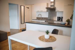 a kitchen with a white table with a plant on it at Wilten 1 in Innsbruck