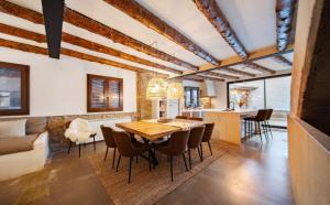 a kitchen and dining room with a wooden table and chairs at ruralhomemora in Mora de Rubielos