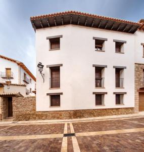 a large white building with windows at ruralhomemora in Mora de Rubielos