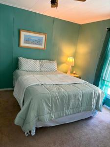 a bedroom with a bed with a green wall at Beach Condo in Ocean City, MD in Ocean City