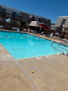 a large swimming pool with a ball in the water at Beach Condo in Ocean City, MD in Ocean City