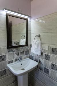 a bathroom with a sink and a mirror at Chandan Guest House in Leh +87 photos