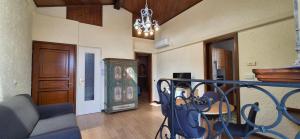 a living room with a couch and a chandelier at Appartamento La Torre in Lenno