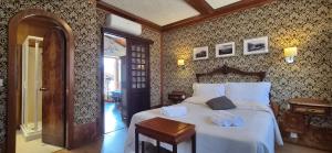 a bedroom with a large white bed with a wooden headboard at Appartamento La Torre in Lenno