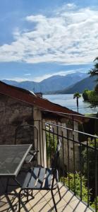 a balcony with a table and a view of a lake at Appartamento La Torre in Lenno