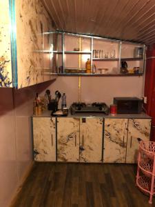a kitchen with a marble counter top and a counter top at Burj Hotel Kottli Sattian in Ban