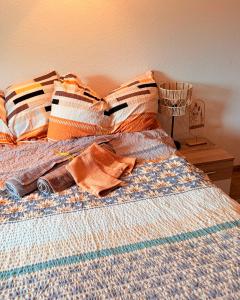 a bed with colorful sheets and pillows on it at Golden Boutique in Basel