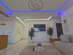 a living room with a couch and a tv on the ceiling at Casa almas in Chefchaouen