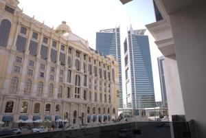 a large building in a city with tall buildings at Royal Palace Hotel - Al Olaya in Riyadh