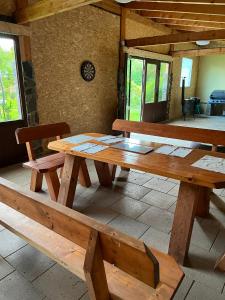 a large wooden table and bench in a room at Chalet pri studenom potoku in Stará Lesná