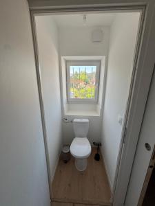 a small bathroom with a toilet and a window at Maison de vacance à DAX in Dax +3 photos