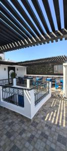 a patio with a fence and a table and chairs at Dar Mounia Les Oudayas in Rabat