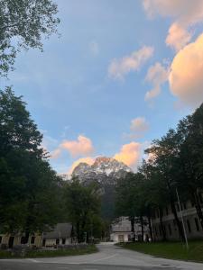 a mountain in the middle of a street with trees at Apartma 35 in Soča