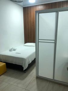 a bedroom with a bed and a sliding glass door at Casa Hotel Ortiz in Apartadó