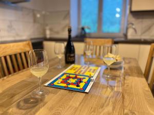 a table with a bottle of wine and two wine glasses at Apartma 35 in Soča