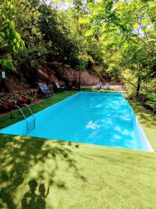 a large blue swimming pool in a yard at Alojamiento Rural El Balcón del Cielo in Trevélez