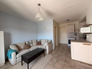 a living room with a couch and a table at Cozy Aegean Escape in Skopelos Town