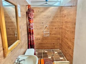 a bathroom with a shower and a sink at Hotel Xetawaa´l in San Pedro La Laguna +55 photos