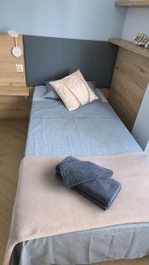 a bedroom with a bed with a pillow on it at Costa blancavibes, Solo Familias in Playa de Gandia