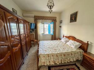a bedroom with a bed and a dresser at Villa cleopatra in Mezraya +41 photos