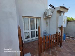 a balcony of a house with a heater and a window at La Casetta in Sarroch