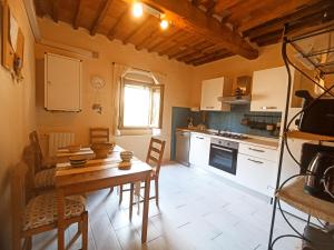 a kitchen with a table and chairs in a room at Il sogno di Tania in Pescia