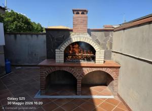 a brick oven with a fire inside of it at La Casetta in Sarroch