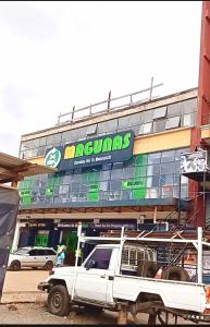 a white truck parked in front of a building at Ruiru Cozy stays in Ruiru