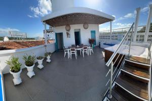 a balcony with a table and chairs on a yacht at Hotel Aldea Plaza in Doradal