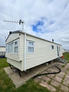 a white tiny house sitting on a trailer at Brand New Caravan in Selsey